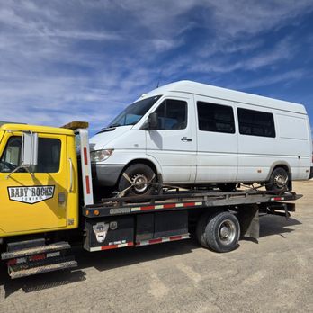 A Baby Rocks Towing flatbed truck providing 24/7 emergency towing and dependable transport services for cars, vans, and larger vehicles.