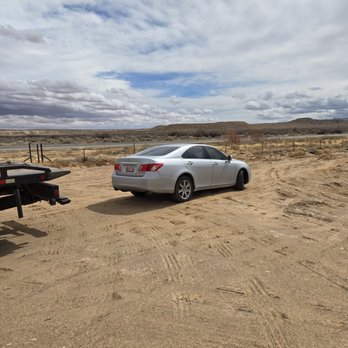 Baby Rocks Towing arriving to provide rapid roadside assistance services, including jump starts, tire changes, and lockout help for a stranded car.